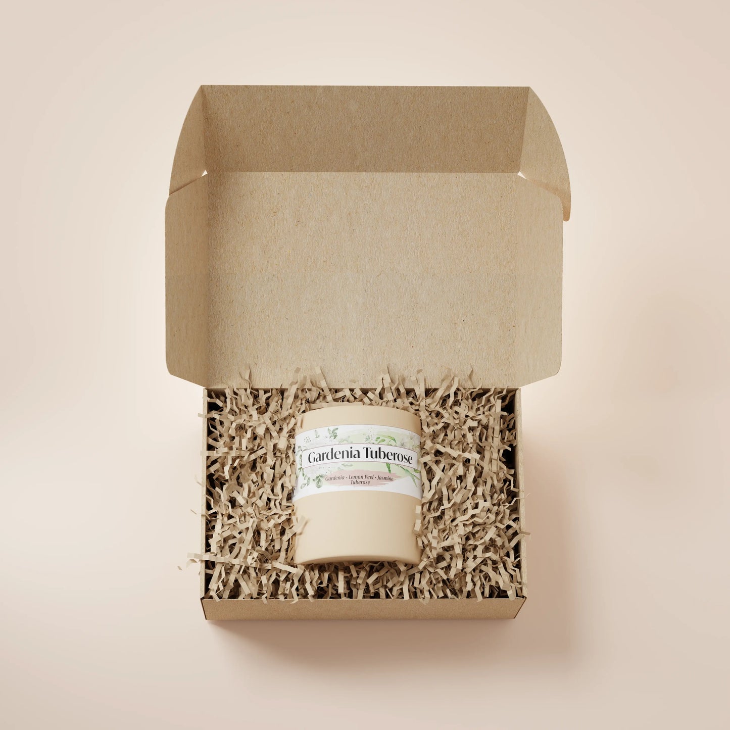 Cream Ceramic 12oz Gardenia Tuberose Scented Candle in a box with crinkle paper.