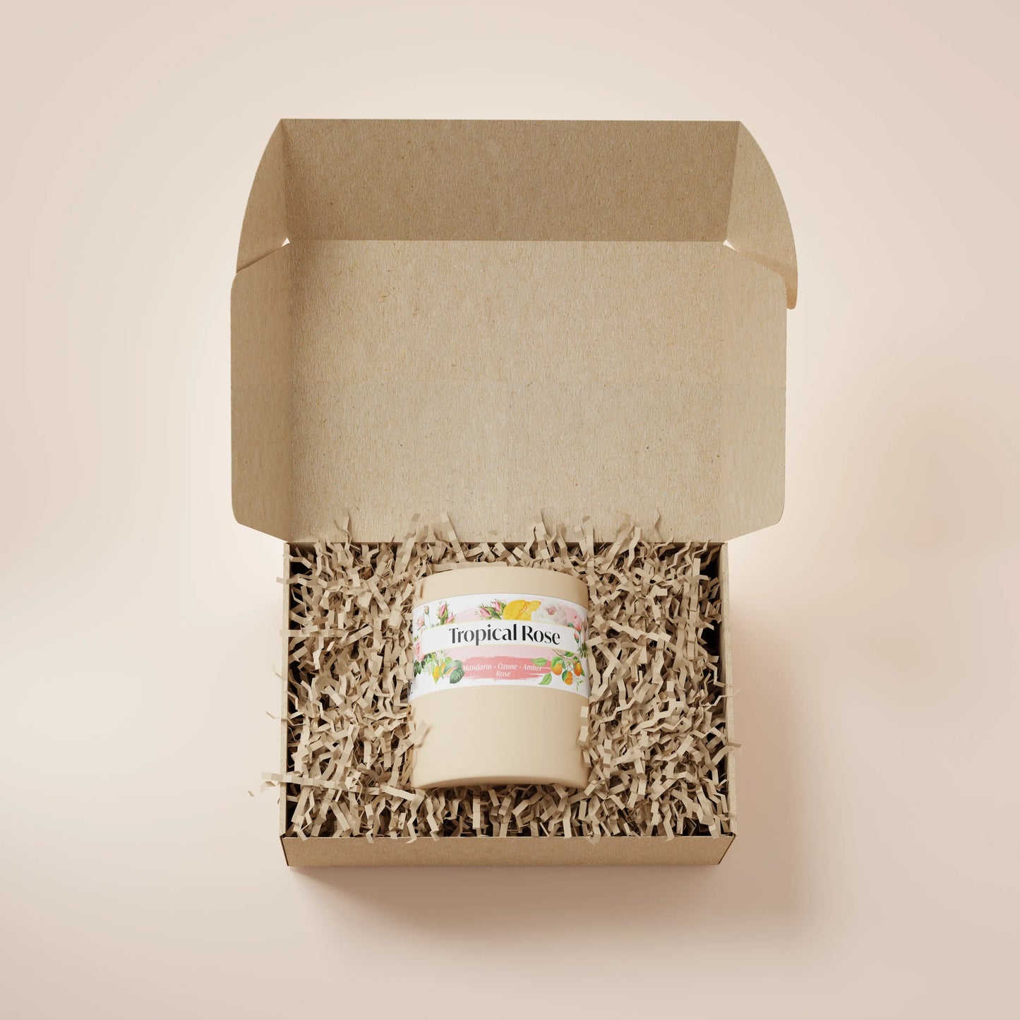 Cream Ceramic 12oz Tropical Rose Scented Candle in a box with crinkle paper.