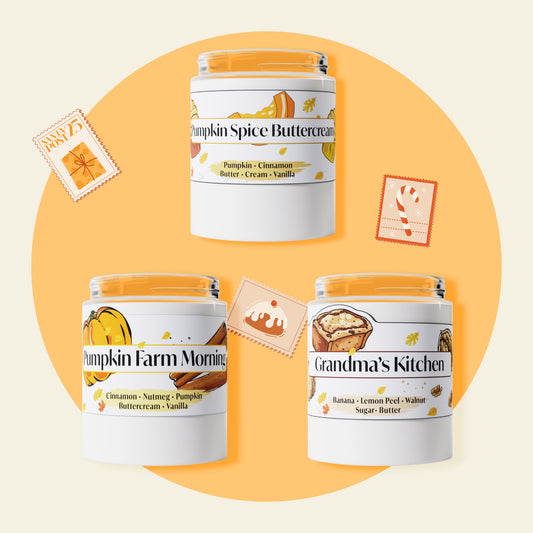 Three fall-themed candles on an orange background