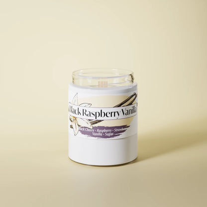 Black Raspberry Vanilla scented candle in a glass vessel on a yellow studio background