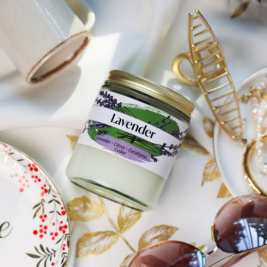 Jar of Lavender Candle on a decorative tablecloth with accessories around it