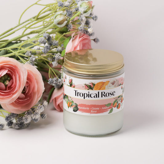 Tropical rose candle on a white background next to roses