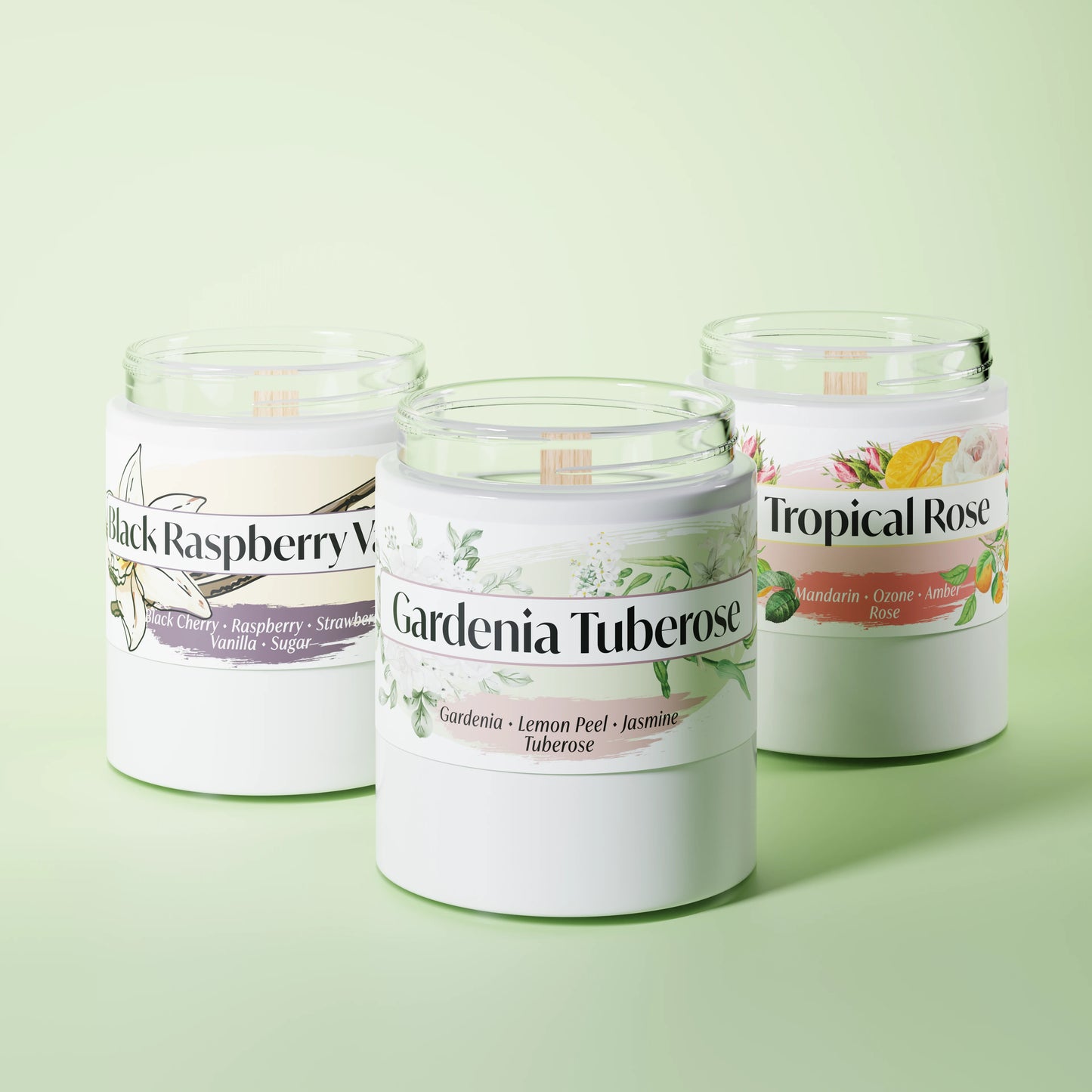 Three scented candles in glass vessels on a light green studio background